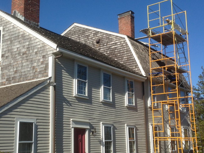 House with scaffolding for chimney repair job